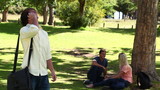 Video: Man laughing as he talks on a phone before hanging up and looking at the camera Man laughing as he talks on a phone before hanging up and looking at the camera
