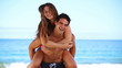 Man giving his girlfriend a piggy-back