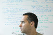 Profile of man in front of white board