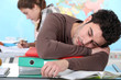 Young man sleeping during a university lecture
