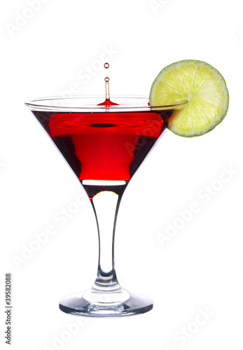Photo: Cocktail with falling drop and lime slice isolated on white Cocktail with falling drop and lime slice isolated on white