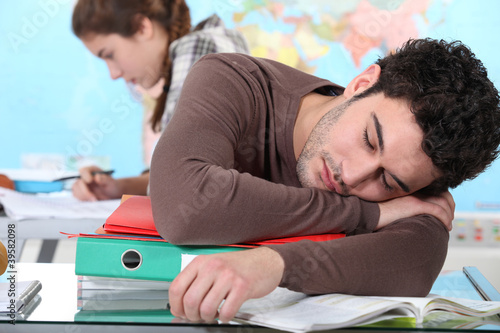 Photo: Young man sleeping during a university lecture Young man sleeping during a university lecture