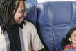Father with young daughter on airplane