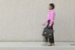 Blurred view of businesswoman walking with briefcase
