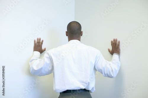 Photo: Businessman leaning into corner Businessman leaning into corner