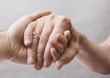 Young hand give help to old hand