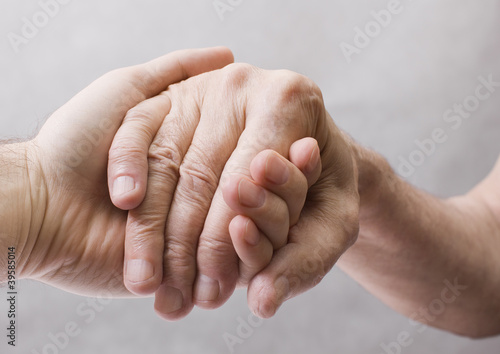 Photo: Young hand give help to old hand Young hand give help to old hand