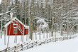Little red house covered by snow