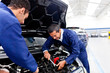 Mechanics fixing a car
