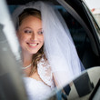 Portrait of a beautiful young bride waiting in the car
