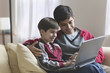 Young father and son using laptop