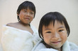 Sister and brother wrapped up in towels