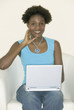Portrait of woman holding laptop