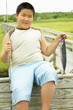 Portrait of boy holding fish