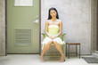 Woman sitting in chair near door