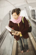 High angle view of woman riding escalator