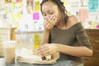 Woman eating sandwich in cafe
