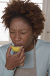 Woman puckering while eating lemon