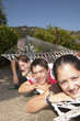 Portrait of teenagers laying on hammock together