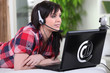 Young woman using a webcam on a laptop