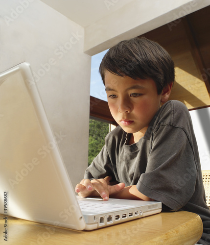Photo: Boy working on computer Boy working on computer