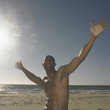 Man raising hands at beach