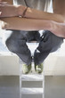 High angle view of man sitting on ladder