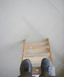 High angle view of man standing at top of ladder