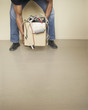 Man lifting cardboard box full of tangled cords