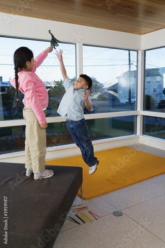 Photo: Girl and boy playing with toy Girl and boy playing with toy