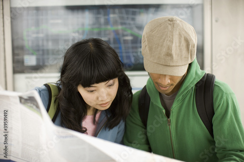 Photo: Young couple looking at map Young couple looking at map