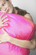 Hispanic woman hugging pillow