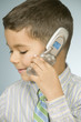 Close up of young boy talking on mobile phone