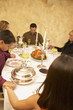 Hispanic family saying grace at dinner table