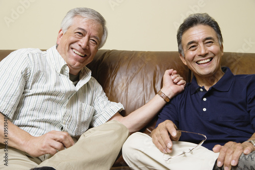 Photo: Portrait of elderly men sitting on the couch laughing Portrait of elderly men sitting on the couch laughing