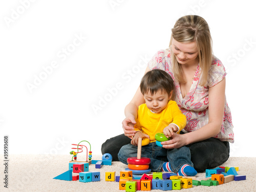 Photo: Mother and son on the carpet with toys Mother and son on the carpet with toys