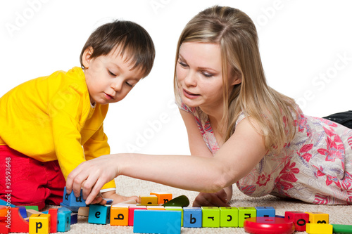 Photo: Mother and son are playing on the carpet Mother and son are playing on the carpet