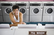 Portrait of man in tank top at laundromat