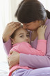 Portrait of mother rocking young daughter