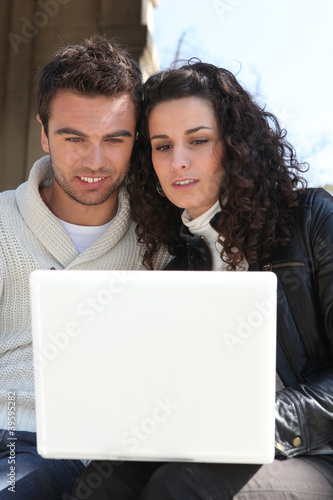 Photo: Couple looking at their laptop Couple looking at their laptop