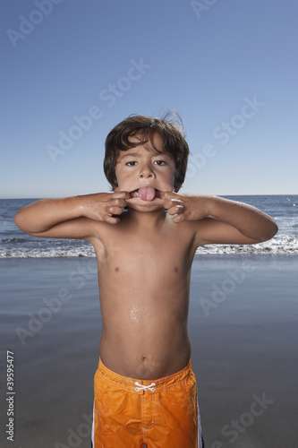 Photo: Portrait of boy making face at beach Portrait of boy making face at beach