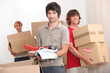 House mates carrying boxes