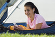 Teenage girl smiling for the camera in a tent
