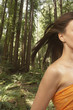 Woman's hair blowing in forest