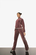 Young woman posing for the camera in a track suit