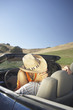 Couple kissing in convertible