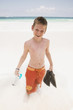 Young boy playing in the water at the beach
