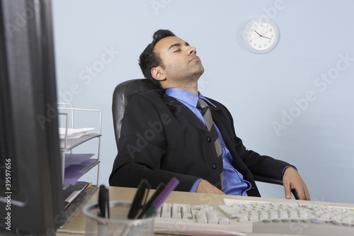 Photo: Businessman asleep at his desk Businessman asleep at his desk