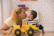 Profile of mother kissing son