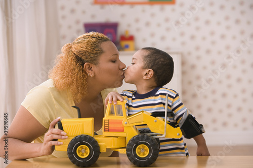 Photo: Profile of mother kissing son Profile of mother kissing son